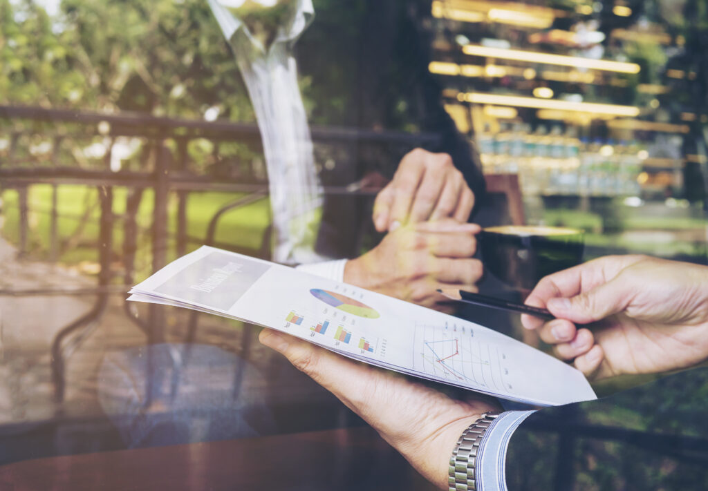 Two businessmen discusses energy sector case studies